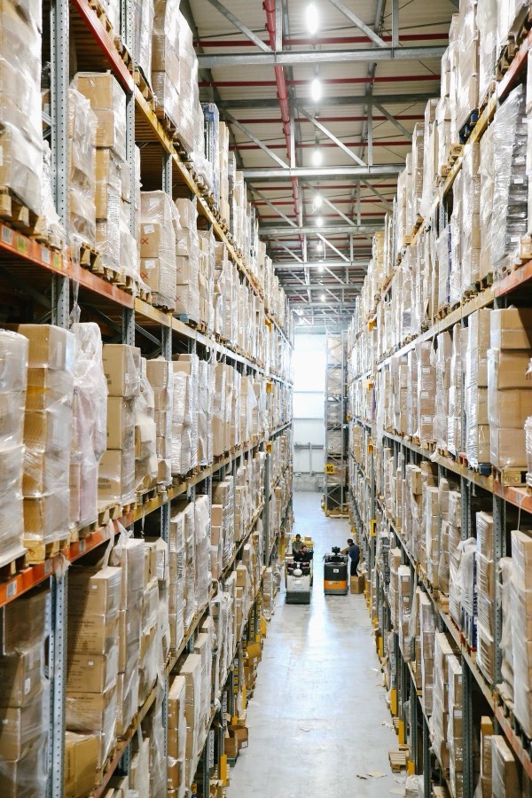Rows of shelving stacked with boxes inside a storage warehouse.